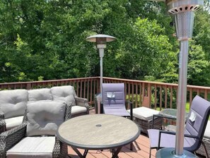 Relax on the patio with a cushioned sofa, lounge chairs, and a round table.