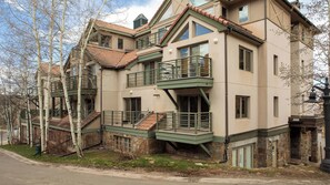 A multi-story building with external staircases, balconies, and a stone facade. - Blue Mesa Lodge 23C by Avantstay Functional Ski In/ski Out Studio w/ Balcony in Great Location! (Telluride)