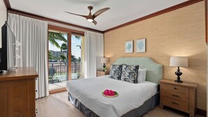 A hotel room with a bed, a desk, a TV, a ceiling fan, and a balcony with curtains. - Hale Moana by Avantstay Incredible Hawaii Beach Resort w/ Pool & Hot Tub! (Kapolei)