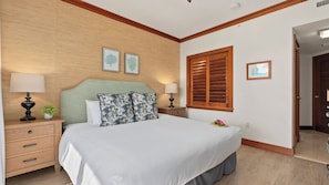 A bedroom with a bed, two bedside tables, a nightstand, a wooden headboard, a window with shutters, and a door. - Hale Moana by Avantstay Incredible Hawaii Beach Resort w/ Pool & Hot Tub! (Kapolei)