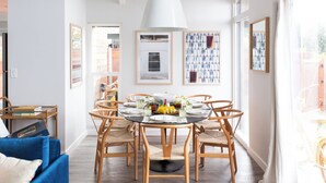 A dining area with a round table, chairs, and a white ceiling light. - Hamilton II by Avantstay Beach House Rooftop Deck Newly Renovated Bungalow (La Jolla)