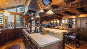 A spacious kitchen with a large island, wooden cabinets, and pendant lighting. - Walk to Palisades Village + Ski Lifts 5BR w/ Mtn Views Mt. Jola by Avantstay (Olympic Valley)