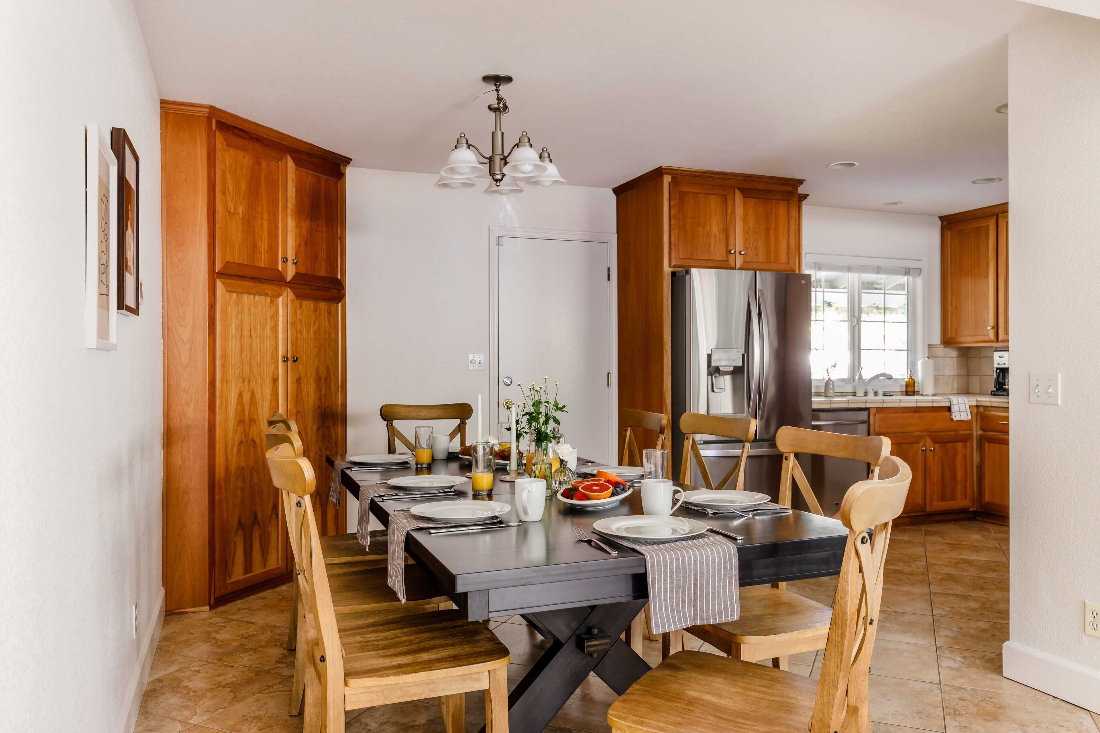 A dining area with wooden chairs and a table set for four.
