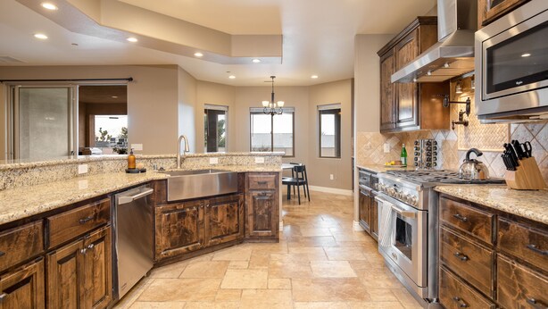 A modern kitchen with granite countertops, stainless steel appliances, and wooden cabinetry. - Gambel by Avantstayjtree Escape w/ Entertainers Yard, & Firepit, 3000sf (Yucca Valley)