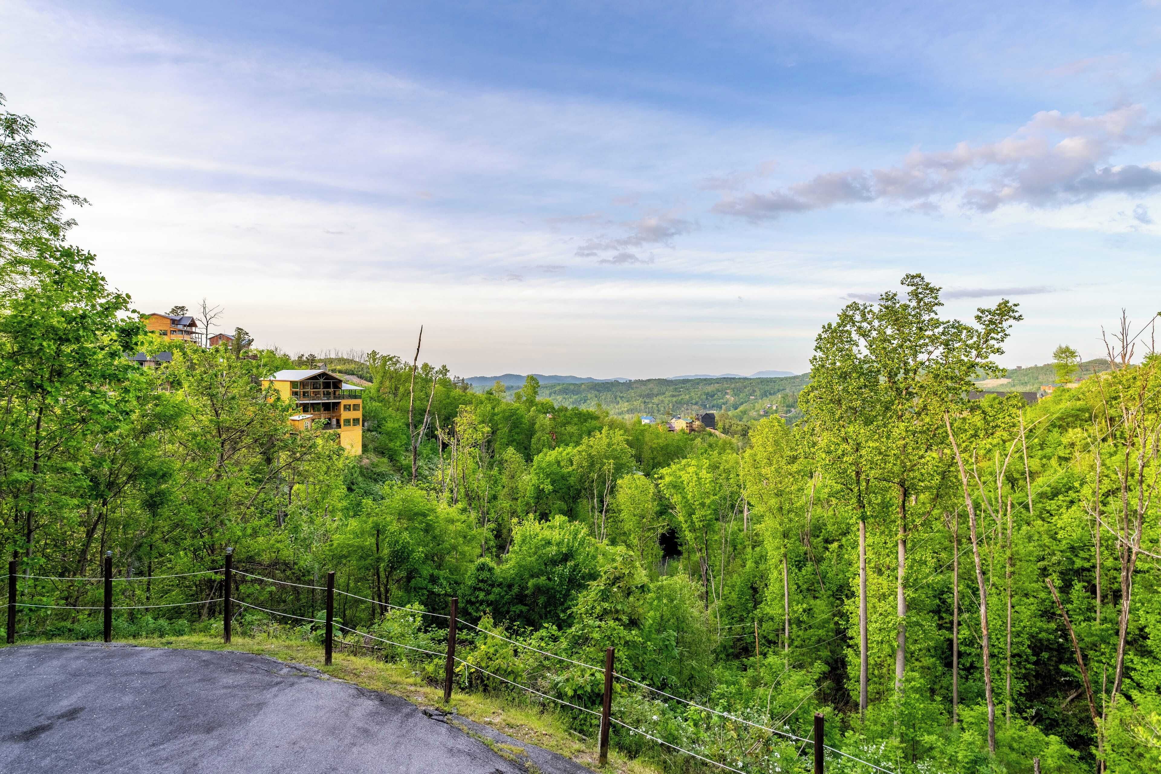 A lush green landscape with a building in the background.