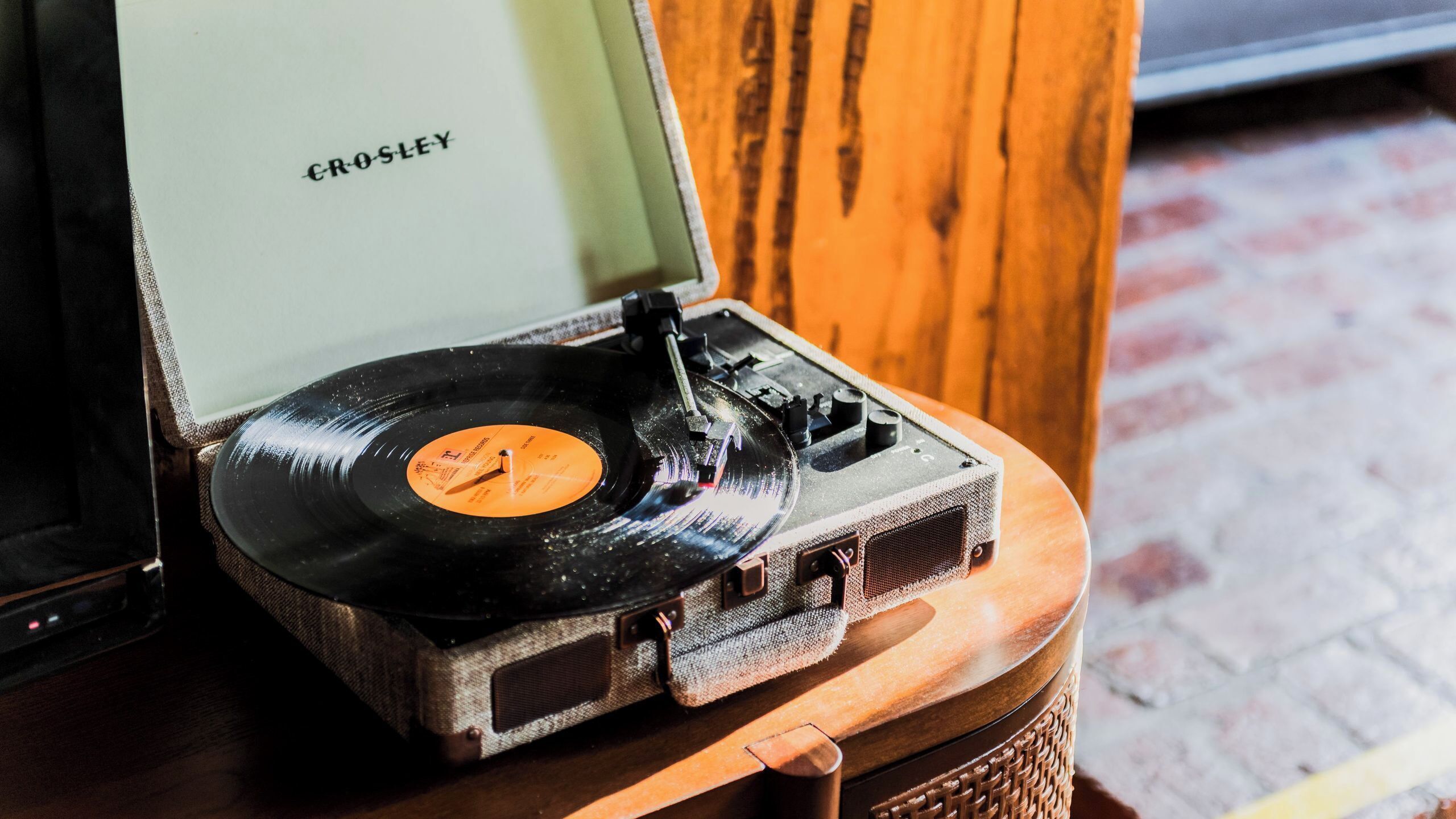 A vintage Crosley turntable on a wooden table.