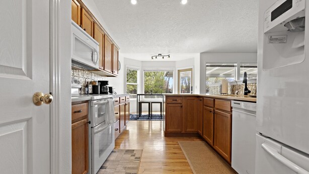 A modern kitchen with wooden cabinets, white appliances, and a central island. - *Backyard*King*Parking*100Mbps*Smart TV*Bbq*W/D (Boise)