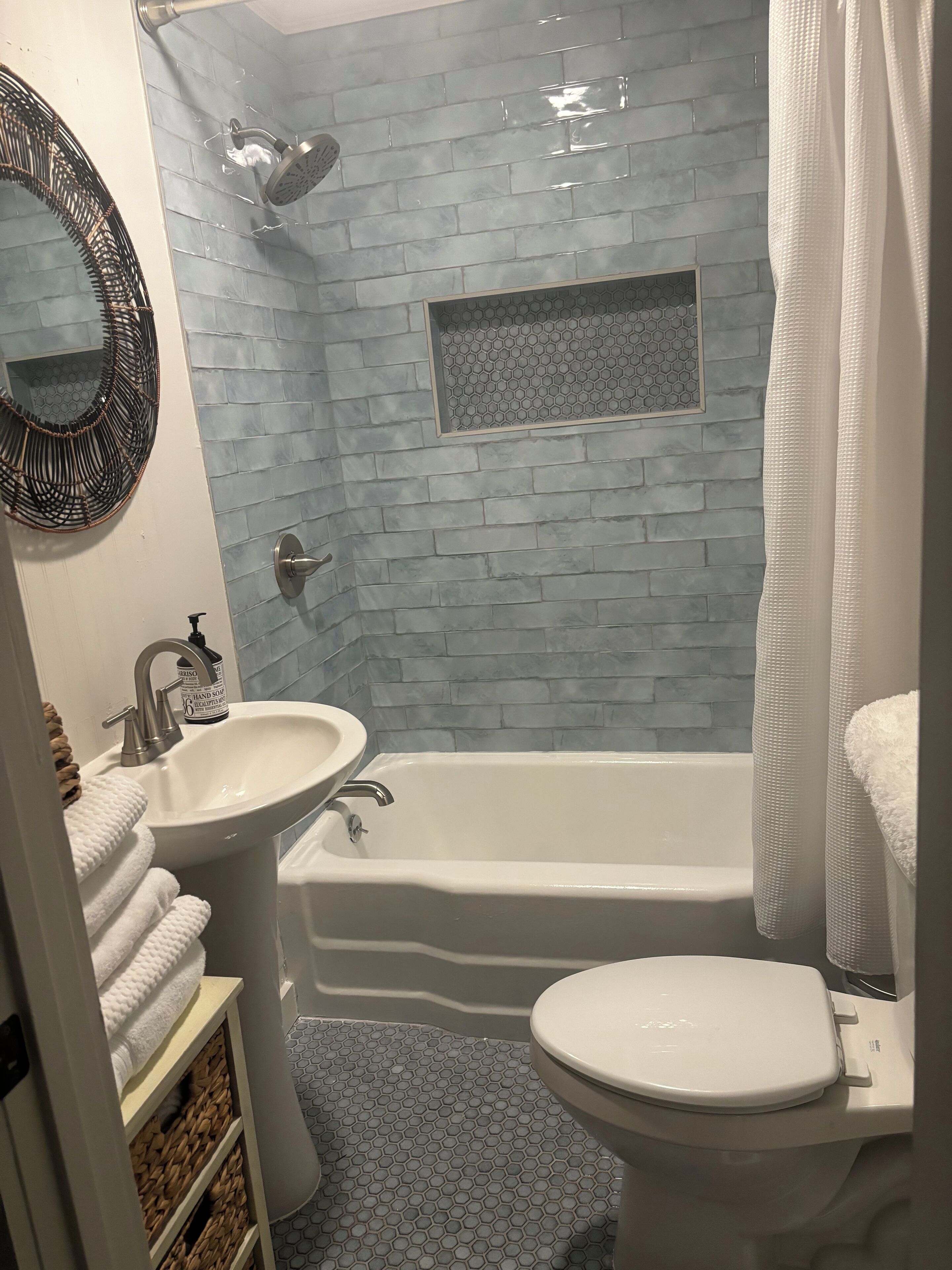 A bathroom with a white sink, a bathtub, and a toilet.