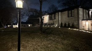A house with a well-lit exterior, a visible front door, and a small porch area. - Urban Ranch, at the Treasure House .. 8 bed 3 bath 2 kitchen + basement suite (Smyrna)