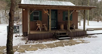 Peaceful cabin in secluded mountain spot beside a picturesque creek