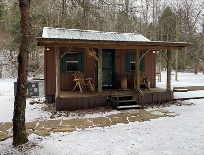 Peaceful cabin in secluded mountain spot beside a picturesque creek