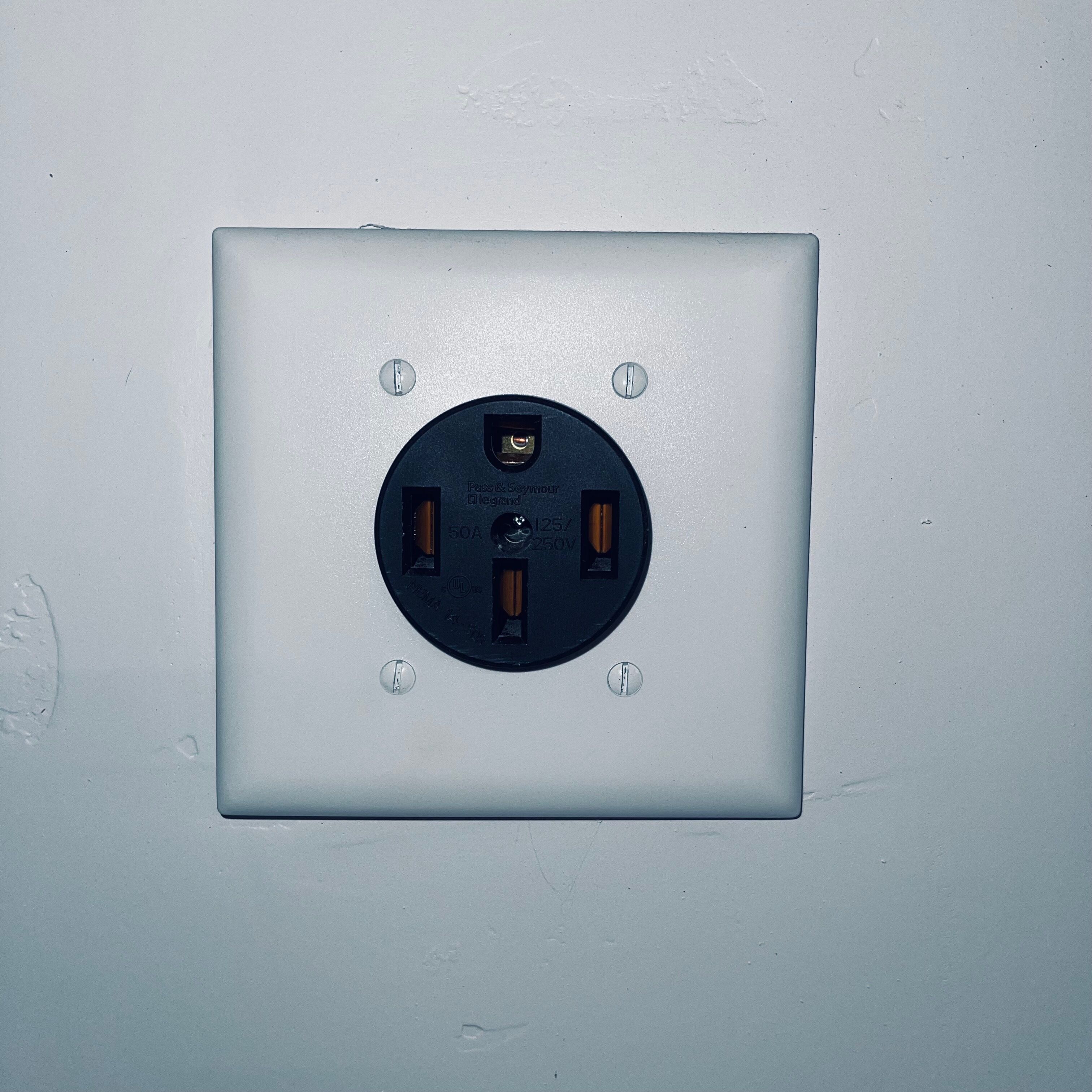 A square electrical outlet with two sockets, a passively cooled switch, and a 50A rating.