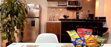 Fridge, microwave, stovetop, coffee/tea maker