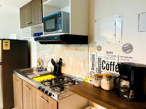Fridge, microwave, stovetop, coffee/tea maker