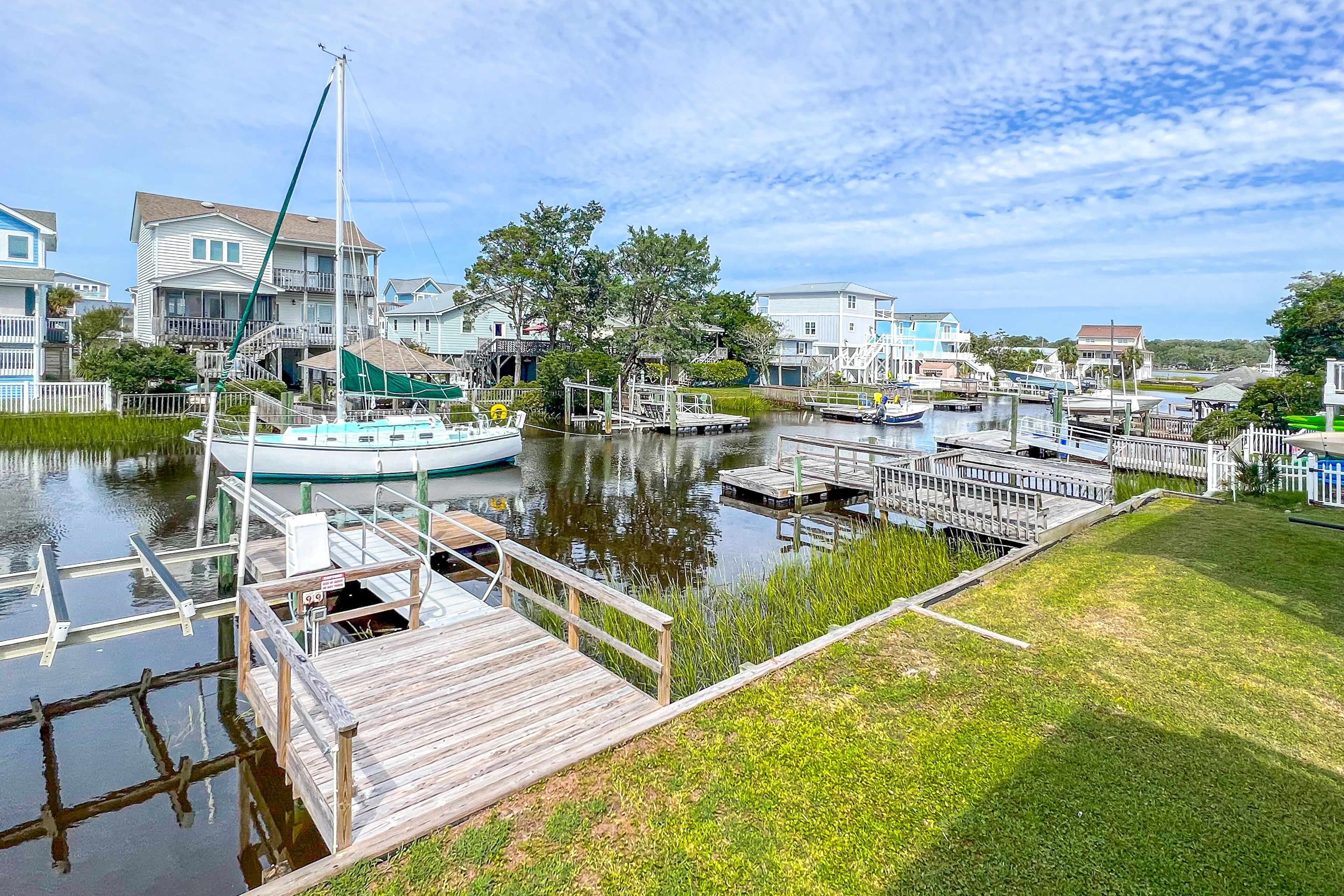 Canal-front home on Holden Beach with dock, deck & beach gear - dog-friendly