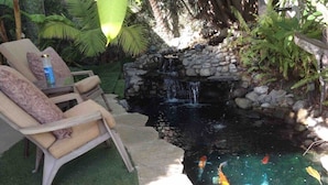 A garden with a pond, koi fish, and a stone waterfall. - Shared Home (Inglewood)