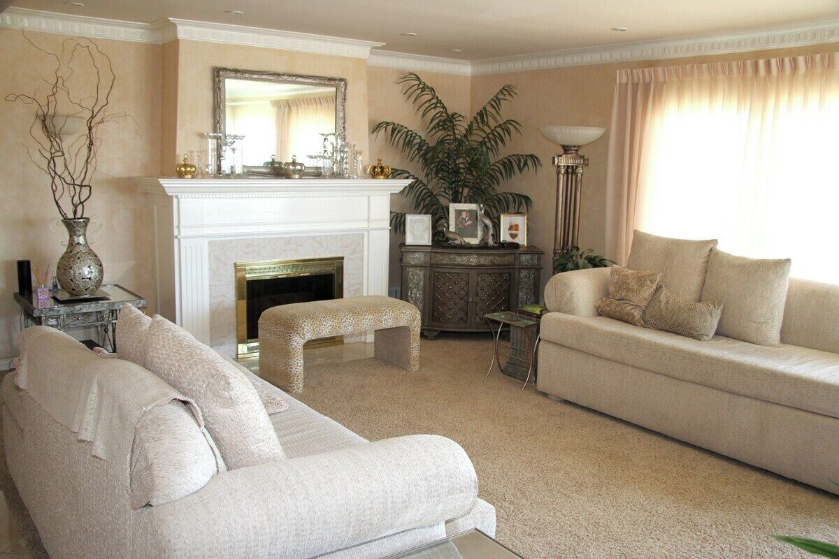 A living room with a fireplace, a sofa, a coffee table, and a lamp.
