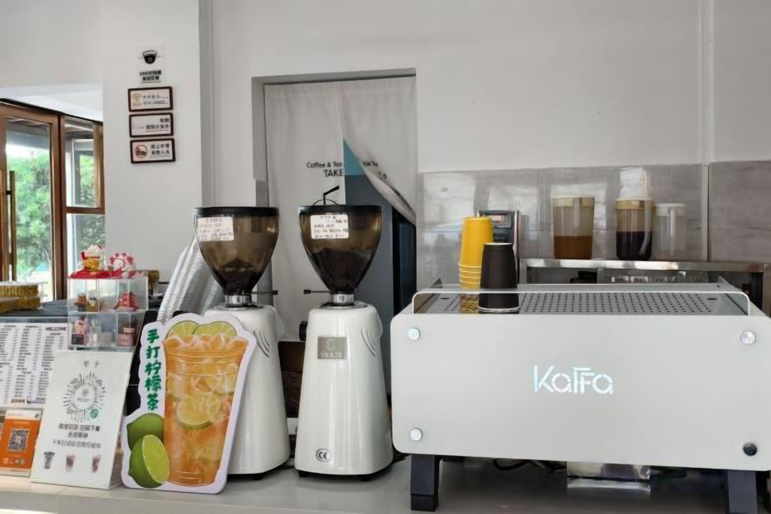 A coffee machine with a branded name, a coffee grinder, and a coffee dispenser.