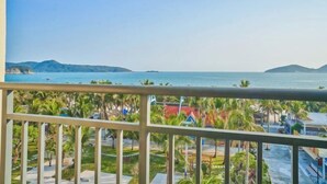 A balcony with a view of a coastal area, including palm trees and buildings. - Haidu Hotel (Taishan)