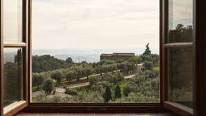 A view through an open window of a building surrounded by olive trees and a road. - Casa Lionardo - House with private pool (Vinci)