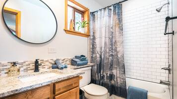 Bathtub, hair dryer, towels, soap