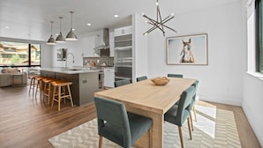 A modern kitchen with a central island, stainless steel appliances, and pendant lighting. - Urban Luxury - Rooftop Patio w/ Hot Tub, Perfect for 2 Families at Competitive Rates (Steamboat Springs)