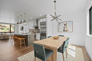 A modern kitchen with a central island, stainless steel appliances, and pendant lighting. - Urban Luxury - A/C - Rooftop Patio w/ Hot Tub - Perfect for 2 Families at Competitive Rates (Steamboat Springs)