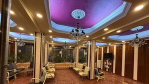 A spacious lobby with a high ceiling, marble flooring, and multiple seating areas. - Otel Büyük Doğu  (Erzurum)