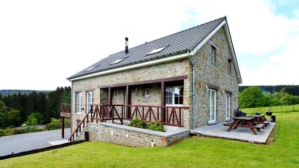 A stone house with a covered porch, a barbecue area, and a view of the surrounding landscape. - Perfect Holiday Home in Trou de Bra with private garden and mountain views (Trou de bra)