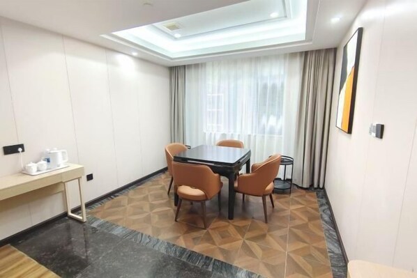 A conference room with a table, chairs, a coffee station, and a view of the outside through large windows. - Zengdu Hotel (Suizhou)