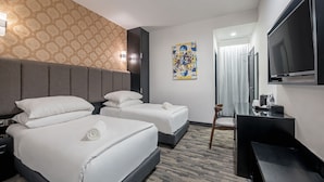 A hotel room with two beds, a flat-screen TV, a desk, and a patterned wall. - HAKO HOTEL JBCC (Johor Bahru)