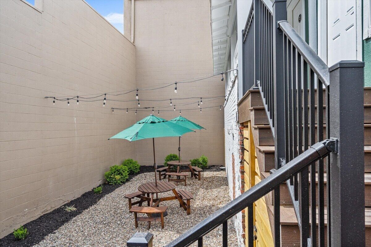 A courtyard with outdoor seating and string lights.