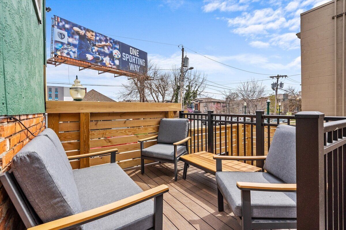 An outdoor seating area with wooden furniture and a view of the cityscape.