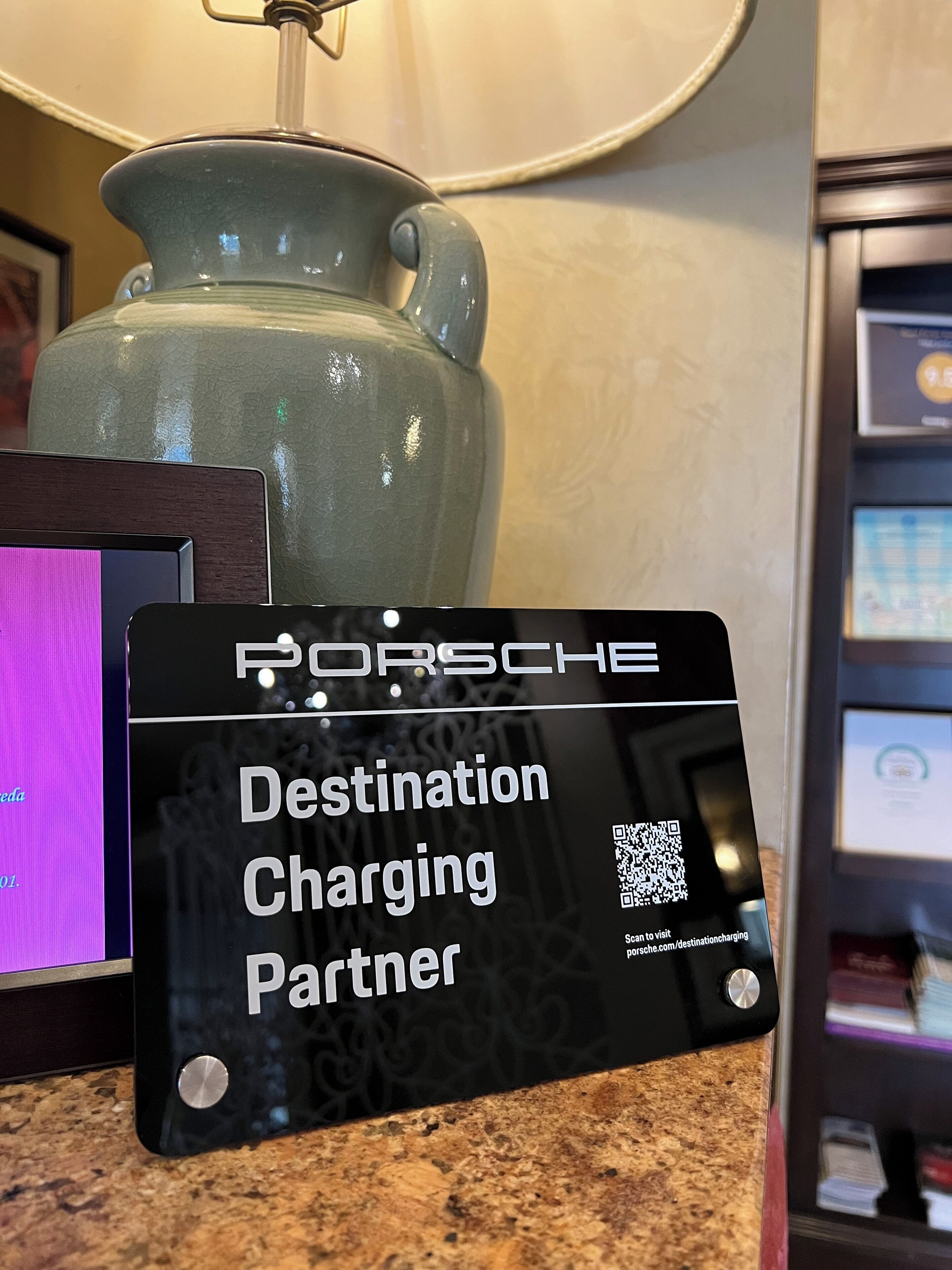 A sign indicating a Porsche destination charging partner.