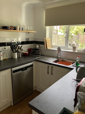 Enjoy cooking in this well-equipped kitchen with a sink, kettle, and ample countertop space.