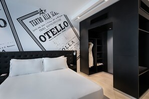 A modern hotel room with a large bed, a wardrobe, and a wall with a vintage poster. - Verdi Gzira Promenade (Gzira)