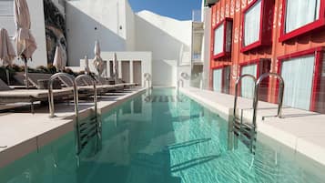 Seasonal outdoor pool, open noon to 8:00 PM, pool umbrellas