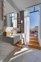 Separate bathtub and shower, rainfall showerhead, hair dryer, bathrobes