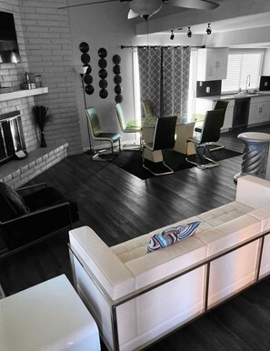 Relax in a spacious living area with a fireplace, perfect for unwinding and dining.