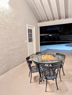 Relax and unwind in this serene outdoor space, perfect for leisure activities, with a pool nearby.
