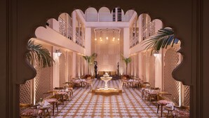 A luxurious interior with a checkered floor, ornate arches, and a central fountain. - juSTa Ssatva Resort - Udaipur (Udaipur)