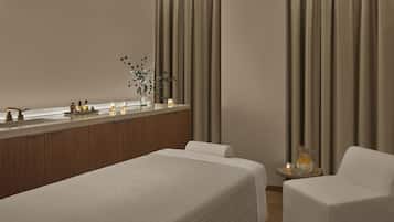 Relax in a serene space with a comfortable bed, seating area, and large window offering a view of the outside.