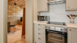 A kitchen with a microwave, oven, and stainless steel cabinets. - The Hayloft at Warren House (Market Rasen)
