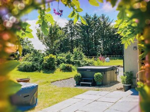 A garden with a shed, a bench, and a small pond. - 2 bedroom accommodation in Stackpole (Stackpole)