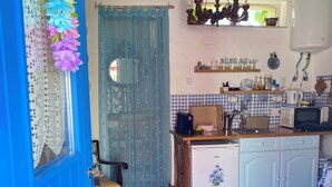 A kitchen with a refrigerator, microwave, and sink. - Casal DOS Carpinteiros 4 (Silveira)