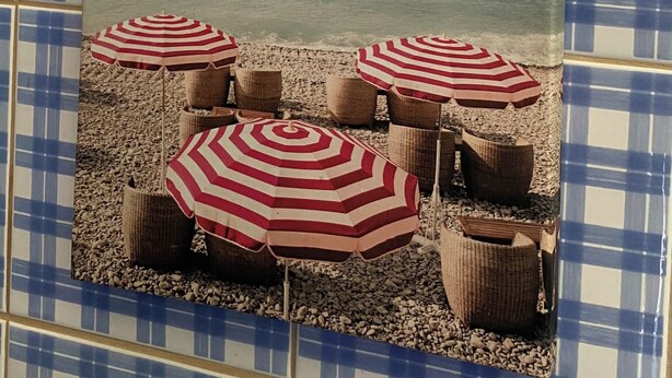 A beach scene with striped umbrellas and wicker chairs. - Casal DOS Carpinteiros 4 (Silveira)