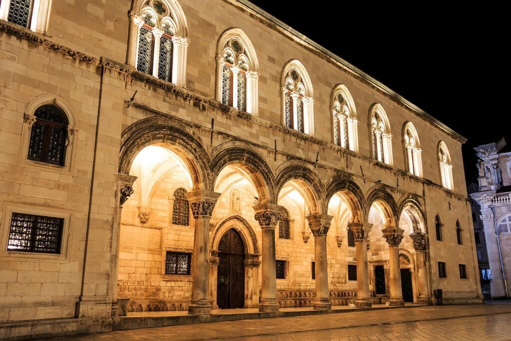 A historic building with arched windows and columns, likely a public or religious building.