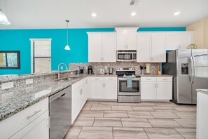 Enjoy cooking in this well-equipped kitchen with a refrigerator, microwave, oven, and dishwasher.