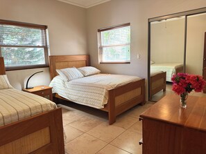 A bedroom with a bed, bedside table, lamp, and a mirror. - Elegant 2-bedroom apartment in Ocean Dream (Cabarete)