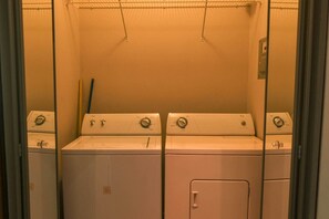 A laundry room with four stacked washers and dryers. - Elegant 2-bedroom apartment in Ocean Dream (Cabarete)